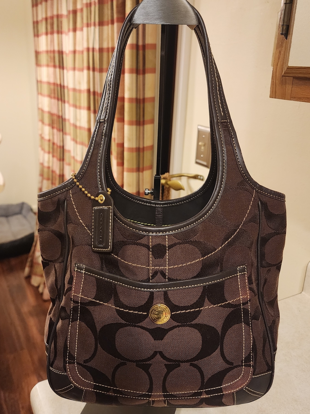 Coach shoulder bag is Signature Ergo Hobo model